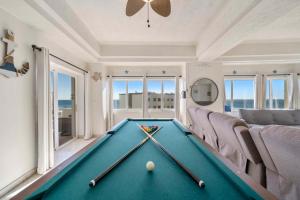 a pool table in a living room with a pool ball at Las Palmas 4BR 4BA Penthouse Ocean View 703 in Campo del Medio +70 photos