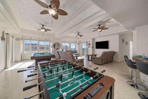 a living room with a pool table and a room with at Las Palmas 4BR 4BA Penthouse Ocean View 703 in Campo del Medio