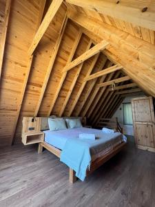 a bedroom with a bed in a wooden attic at KiDRAK OTEL MONTENEGRO-1 in Faralya