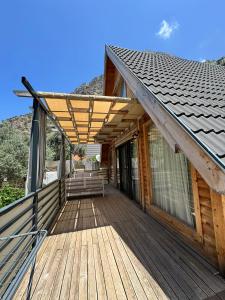 a wooden deck with a roof on a house at KiDRAK OTEL MONTENEGRO-1 in Faralya