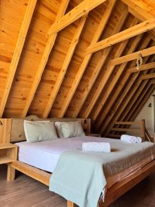 a bed in a room with a wooden ceiling at KiDRAK OTEL MONTENEGRO-1 in Faralya