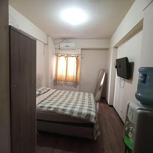 Ένα ή περισσότερα κρεβάτια σε δωμάτιο στο Suitesmetro Apartment