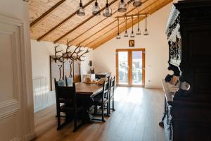a dining room with a table and chairs at Cerma Bucovina in Marginea
