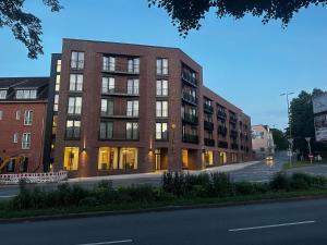 a large brick building on a city street at Central Hotel in Flensburg