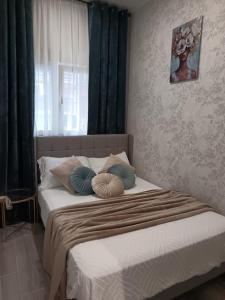 a bed with two pillows on it in a bedroom at BOUTIQUE LUXURY City Center in Alicante