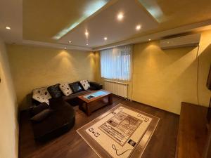 a living room with a couch and a table at Къща Добринище in Dobrinishte