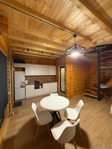 a kitchen and dining room with a table and chairs at Лесник in Cholpon-Ata