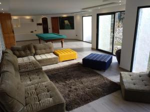 a living room with a couch and a pool table at Chalet Monterrey in Real de Gandía