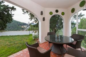 a patio with a table and chairs with a view at Chalet Monterrey in Real de Gandía