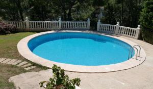 a large swimming pool with a white fence around it at Chalet Monterrey in Real de Gandía