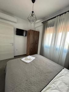 a bedroom with a bed with a tray on it at Olympiada Complex Calma Di Mare Apartment in Ofrínion +23 photos
