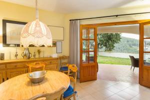 a kitchen with a wooden table and a dining room at Chalet Monterrey in Real de Gandía