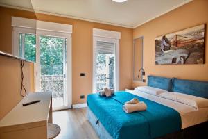 Un dormitorio con una cama azul con dos toallas encima. en Daisy Rooms Cinque Terre, en La Spezia