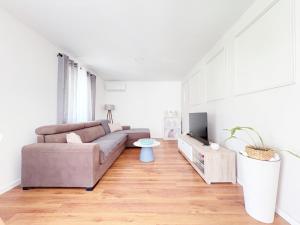 a living room with a couch and a tv at House9 in Kotor