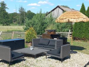 a patio with a table and chairs and an umbrella at Chillout-House in Mińsk Mazowiecki