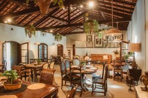 a restaurant with tables and chairs in a room at Vale Zirá in Vassouras