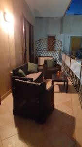 a living room with two chairs and a table at Finestra su Velia in Marina di Ascea +1 photo