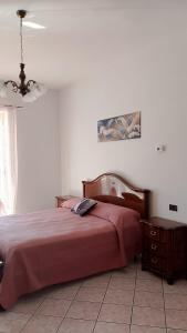 a bedroom with a bed with a red bedspread at Finestra su Velia in Marina di Ascea