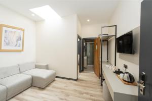 TV a/nebo společenská místnost v ubytování Fora Inn Lara