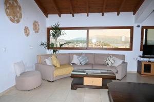 a living room with a couch and a coffee table at Hotel Marku in Ksamil