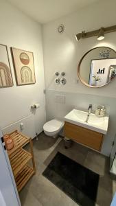 a bathroom with a sink and a toilet and a mirror at Bostel 96 - Apartment, Altstadt, Aufzug in Moers