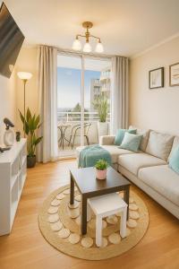 a living room with a couch and a table at Departamento Familiar en el centro in Santiago