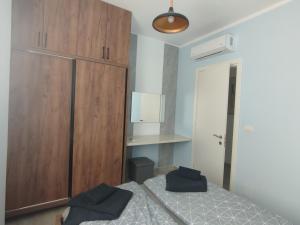 a bedroom with a bed and a large wooden cabinet at U laguny 404 in Shëngjin