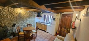 a kitchen with a table and a kitchen with a refrigerator at Bolera I in Borines