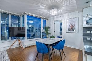 a dining room with a table and blue chairs at Downtown Condo with Great City Views in Vancouver
