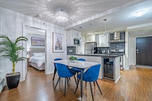 a kitchen and living room with a table and chairs at Downtown Condo with Great City Views in Vancouver