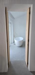 a large white tub sitting inside of a room at Casa d'Aldeia in Sonega