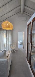a living room with a couch and a chandelier at Casa d'Aldeia in Sonega +16 photos