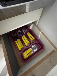 a drawer in a cabinet with utensils in it at VivaVida boungavilli 01 in Sinop +10 photos