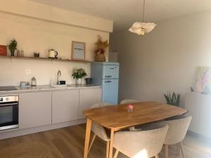 a kitchen with a wooden table and a dining room at Charming house in Vergisson