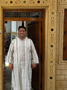 a man standing in front of a door at Riad Serendipity in Fès