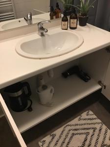 a bathroom counter with a sink and a mirror at Chambre Cosy 3 in Montauban +14 photos
