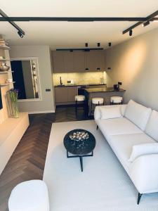 a living room with a white couch and a table at Portside living in Klaipėda