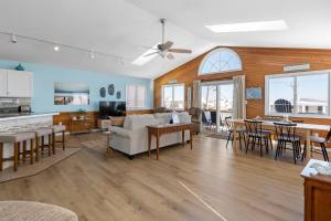 a living room with a couch and a table at Coasties Ocean Breeze in Kill Devil Hills