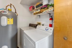 a small laundry room with a washer and dryer at Color Me Beachy in Rodanthe