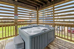 a hot tub sitting on a wooden deck at Color Me Beachy in Rodanthe