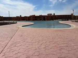 a swimming pool in front of a building at Chalet Amexico Paradise - Ain Sokhna familys only in Az Za‘farānah +16 photos