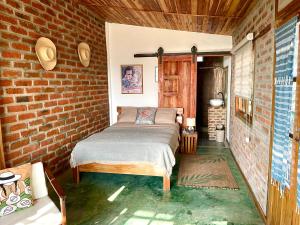 Postel nebo postele na pokoji v ubytování Nativo Lodge Cabaña