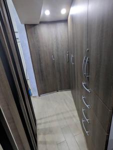 a hallway with wooden cabinets and a tile floor at Studio with Amazing Beach view in Porlamar
