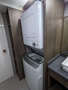 a bathroom with a toilet with a paper dispenser on it at Studio with Amazing Beach view in Porlamar