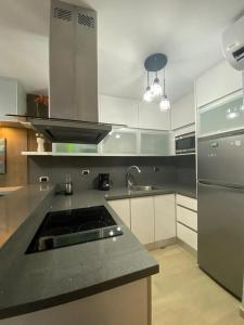 a kitchen with a sink and a stove in it at Studio with Amazing Beach view in Porlamar +12 photos