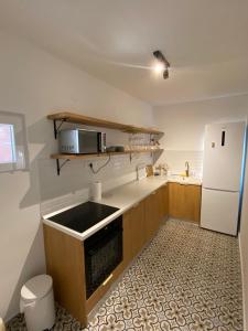 a kitchen with a sink and a white refrigerator at Boka Bliss in Zelenika +5 photos