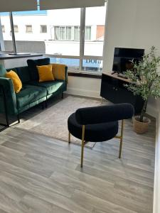 a living room with a couch and a chair at Apartment - Poole High Street in Poole