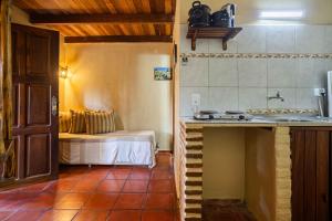 a kitchen with a sink and a bed in a room at Pousada Chale Creoulo in Jericoacoara +86 photos