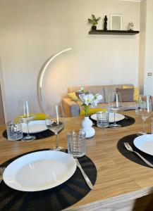 a table with plates and wine glasses on it at Oasi di Pace in Lecce +6 photos