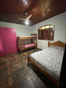 a bedroom with a bed and a bench in it at Chácara Curuco in Mairinque +13 photos